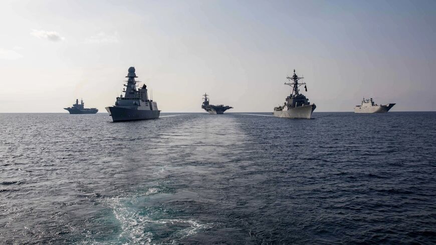 The Nimitz-class aircraft carrier USS George H.W. Bush (CVN 77) sails in formation with the Arleigh Burke-class guided-missile destroyer USS Delbert D. Black.