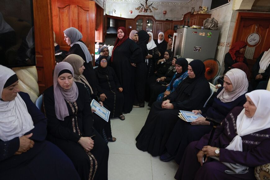 Women gather to offer condolences to the family of a 23-year-old Palestinian man killed during an attack by Jewish settlers on the West Bank village of Jit