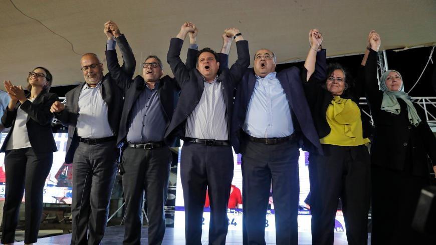 (L to R) Heba Yazbak, member and candidate for the Balad (National Democratic Alliance) party that is part of the Joint List alliance, applauds as Osama Saadi, member and candidate for the Arab Movement for Change (Taal) party raises his hands together with Balad party member and candidate Mtanes Shehadeh, Hadash (Democratic Front for Peace and Equality) party's chairman and candidate Ayman Odeh, Taal's leader and candidate Ahmad Tibi, Hadash's member and candidate Aida Touma, and the Islamic Movement's mem