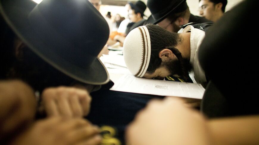 Jewish worshippers pray at Joseph's Tomb as hundreds of faithful mark the anniversary of the biblical Joseph's death, Nablus, West Bank, July 4, 2011. 