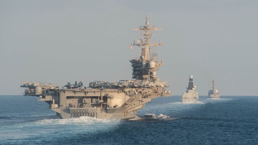 In this handout photo provided by the US Navy, the aircraft carrier USS Abraham Lincoln (CVN 72), left, the Royal Navy air defense destroyer HMS Defender (D 36) and the guided-missile destroyer USS Farragut (DDG 99)