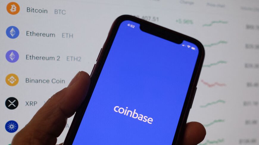 This illustration photo shows the Coinbase logo on a smartphone in Los Angeles on April 13, 2021. 