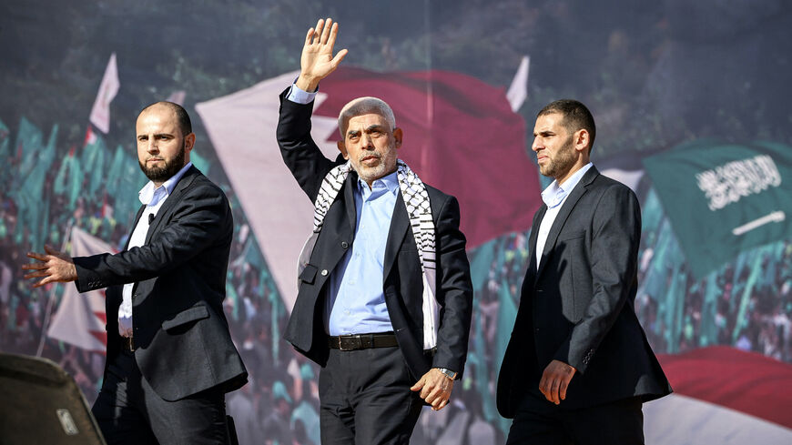 Yahia al-Sinwar (C), Gaza Strip chief of the Palestinian Islamist Hamas movement, waves to supporters during a rally marking the 35th anniversary of the group's foundation, in Gaza City on Dec. 14, 2022. 