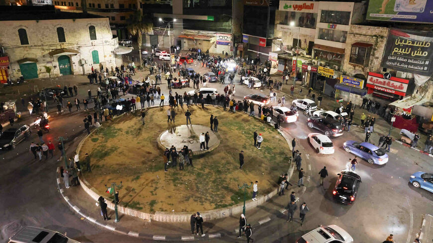 Palestinian youths celebrate following the news of an attack in a settler neighborhood in Israeli-annexed east Jerusalem, in the center of Nablus, West Bank, Jan. 27, 2023.