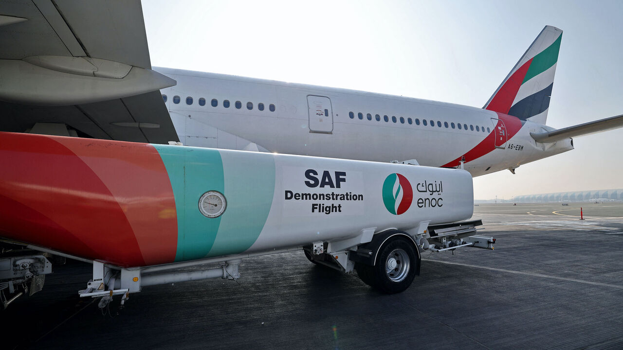 Ground crews prepare an Emirates Boeing 777-300ER aircraft, powering one of its engines with a hundred per cent Sustainable Aviation Fuel (SAF), for a demonstration flight at the Dubai International Airport in Dubai, on January 30, 2023. - Emirates said it successfully flew a Boeing 777 powered by sustainable aviation fuel today, as the Middle East's largest airline aims to halve its jet fuel consumption. The Dubai-based carrier has used sustainable aviation fuel (SAF) since 2017, but said its test flight w