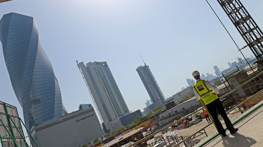 Workers work on the construction site of the Golden Gate towers at Bahrain Bay in Manama on March 25, 2023. - With a multi-billion dollar economic revamp in full swing, tiny Bahrain is vying to keep pace with its Gulf neighbours after more than a decade beset by political unrest. (Photo by Mazen Mahdi / AFP) (Photo by MAZEN MAHDI/AFP via Getty Images)