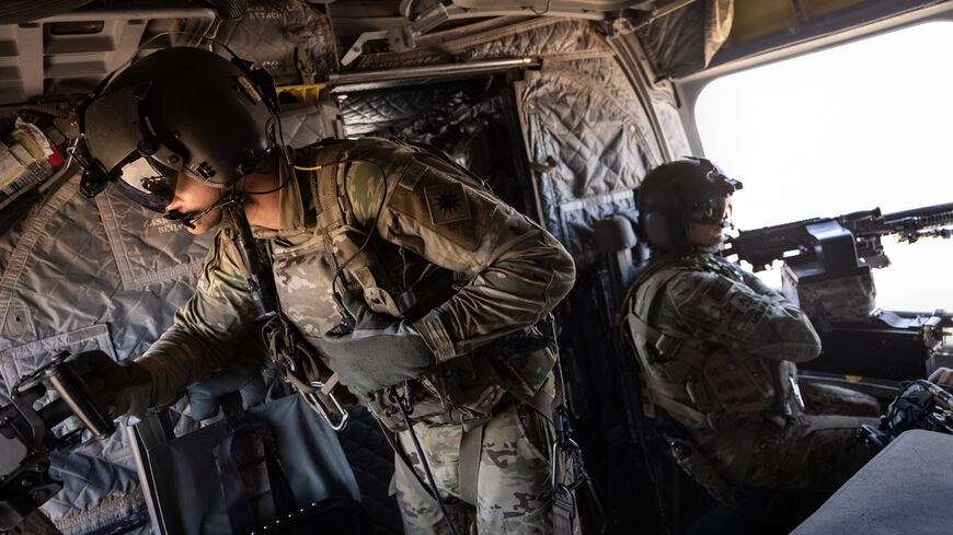 NORTHEASTERN SYRIA - MAY 26: U.S. Army CH-47 Chinook helicopter gunners scan the desert while transporting troops on May 26, 2021 over northeastern Syria. U.S. forces, part of Task Force WARCLUB operate from remote combat outposts in northeastern Syria, coordinating with the Syrian Democratic Forces (SDF) in combatting residual ISIS extremists and deterring pro-Iranian militia. (Photo by John Moore/Getty Images)