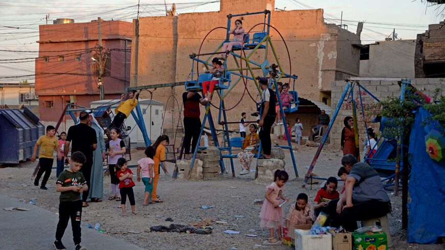 Iraqi children gather at a playground in the old city of Mosul on June 30, 2023 during the Muslim feast of Eid al-Adha. (Photo by Zaid AL-OBEIDI / AFP) (Photo by ZAID AL-OBEIDI/AFP via Getty Images)