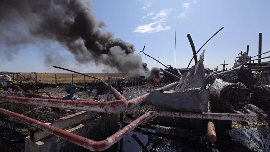  Smoke billows from the Babasi oil facility in the countryside of al-Qahtaniya in Syria's Kurdish-controlled northeastern Hasakeh province on October 6, 2023 following a Turkish strike. (Photo by Delil souleiman / AFP) / "The erroneous mention[s] appearing in the metadata of this photo by Delil souleiman has been modified in AFP systems in the following manner: [BABASI] instead of [BASBASI]. Please immediately remove the erroneous mention[s] from all your online services and delete it (them) from your serve