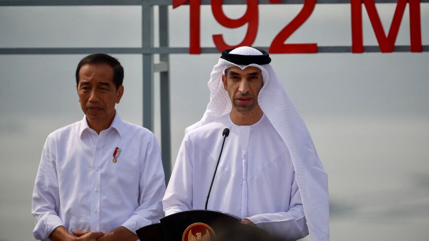 Indonesian President Joko Widodo (L) listens to a speech by United Arab Emirates (UAE) Minister of State for Foreign Trade Thani Ahmed Al Zeyoudi (R) during the inauguration of the newly built floating solar power plant on the water that can generate 192 mega watts of peak electricity in cooperation between the Indonesian government and Masdar from the UAE, at Cirata Reservoir, West Java, on November 9, 2023. (Photo by BAY ISMOYO / AFP) (Photo by BAY ISMOYO/AFP via Getty Images)