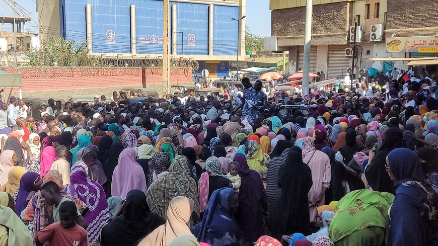 People from states of Khartoum and al-Jazira, displaced by the ongoing conflict in Sudan between the army and paramilitaries, queue to receive aid from a charity organisation in Gedaref on December 30, 2023. (Photo by AFP) (Photo by -/AFP via Getty Images)