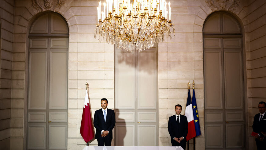 French President Emmanuel Macron (R) and Qatar's Emir Sheikh Tamim bin Hamad al-Thani attend an agreement signing ceremony at the Elysee Palace, in Paris on Feb. 27, 2024.