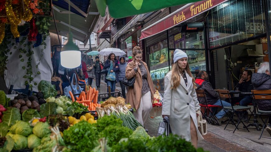 People walk at Kadikoy district in Istanbul on March 5, 2024. Turkey's annual inflation rose again in February, reaching 67.1 percent despite a string of interest rate hikes, official data showed on Monday. The Turkish central bank held its key interest rate at 45 percent last month, pausing after eight straight increases aimed at taming consumer prices that had remained stable at 64.9 percent in January. 