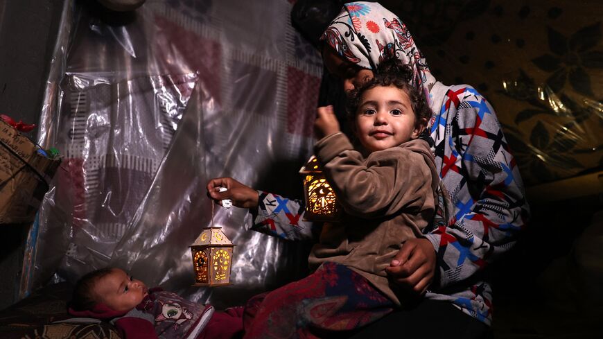 Amid ongoing battles between Israel and the militant group Hamas, Palestinian children in Gaza play with traditional "fanous" lanterns as Muslims prepare for the holy month of Ramadan, Rafah, March 2, 2024.