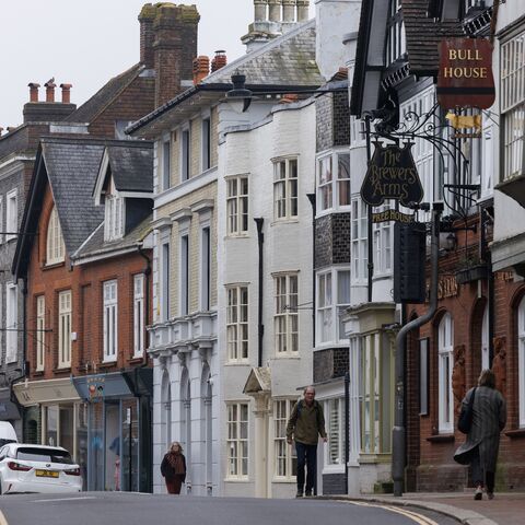 Members of the public walk along the high street on March 21, 2024, in Lewes, England. 