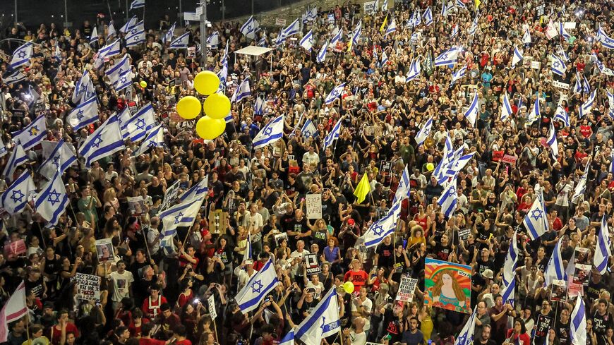 Israeli anti-government protesters prepare to release yellow balloons during a demonstration demanding action to release the hostages taken captive by Palestinian militants in the Gaza Strip in the Oct. 7 attacks, central Tel Aviv, July 6, 2024.