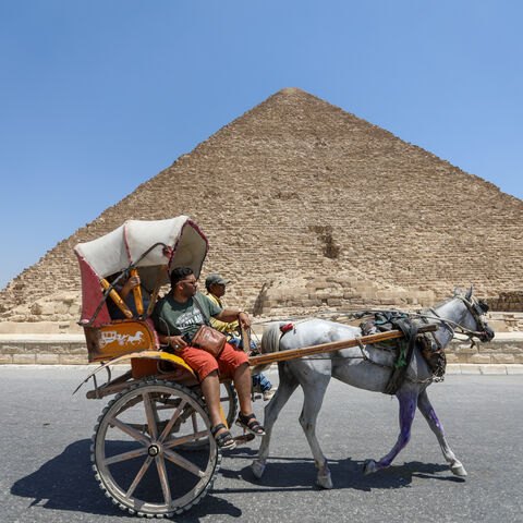  Tourists walk past the pyramids of Khufu, Khafre, and Menkaure on July 21, 2024 in Giza, Egypt. The colossal tombs near Cairo, built around 4,500 years ago for Pharaoh Khufu and completed circa 2560 BCE, are the only surviving wonders of the original Seven Wonders of the Ancient World. (Photo by Ahmad Hasaballah/Getty Images)