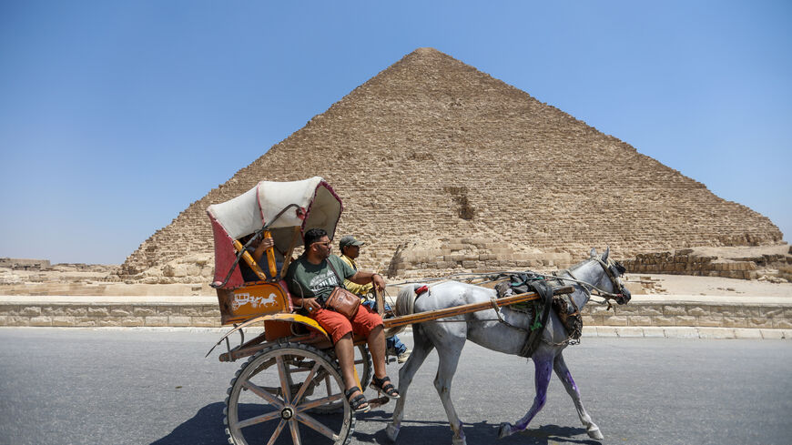  Tourists walk past the pyramids of Khufu, Khafre, and Menkaure on July 21, 2024 in Giza, Egypt. The colossal tombs near Cairo, built around 4,500 years ago for Pharaoh Khufu and completed circa 2560 BCE, are the only surviving wonders of the original Seven Wonders of the Ancient World. (Photo by Ahmad Hasaballah/Getty Images)