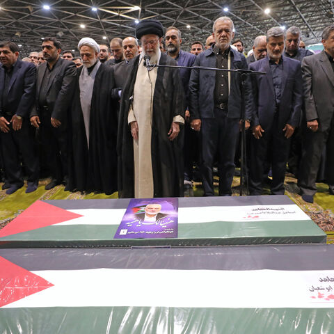 TEHRAN, IRAN - AUGUST 1: (EDITOR'S NOTE: This Handout image was provided by a third-party organization and may not adhere to Getty Images' editorial policy.) In this handout image from the Office of the Iranian Supreme Leader, Supreme Leader Ayatollah Ali Khamenei, center, leads a prayer over the coffins of Hamas leader Ismail Haniyeh and his bodyguard who were killed in an assassination blamed on Israel on Wednesday, during their funeral ceremony at the Tehran University campus on August 1, 2024 in Tehran,