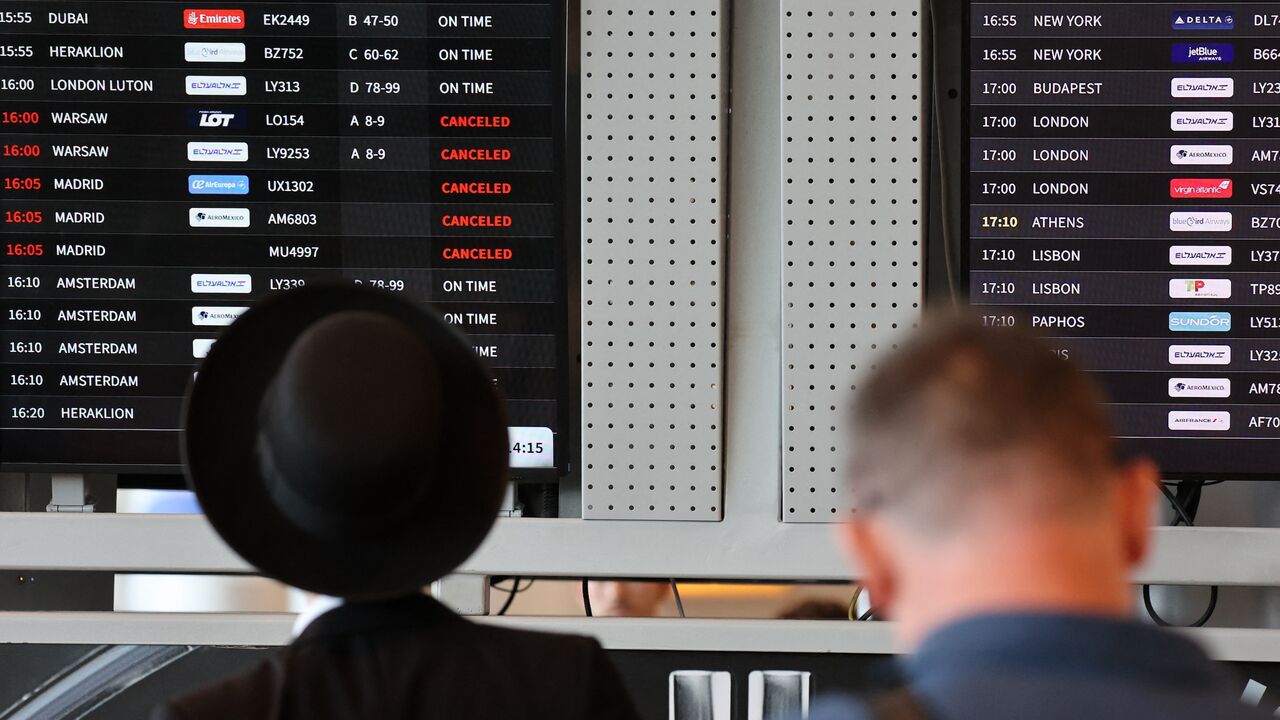 Passengers look at the flight board at Ben Gurion Airport near Tel Aviv on Aug. 6, 2024.