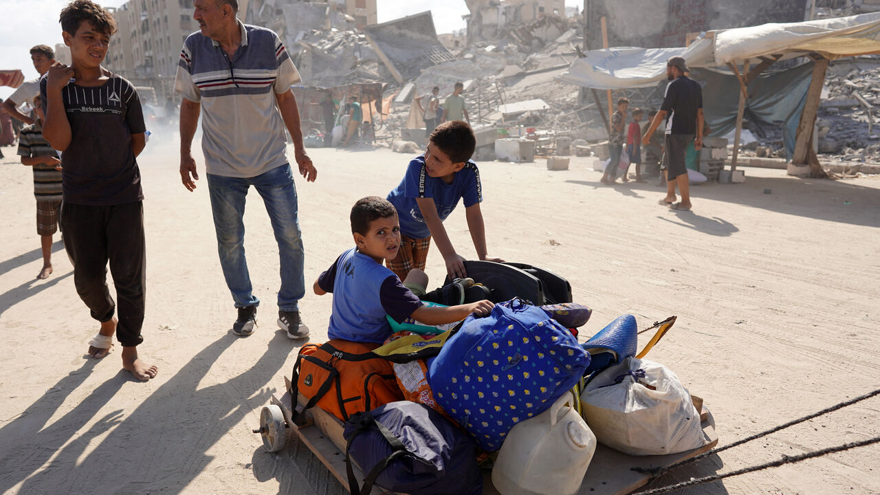 Palestinians flee the Hamad residential district and its surroundings in Khan Yunis in the southern Gaza Strip after receiving a warning from the Israeli army to evacuate the area on August 11, 2024, amid the ongoing conflict between Israel and the Hamas militant group. (Photo by Bashar TALEB / AFP) (Photo by BASHAR TALEB/AFP via Getty Images)