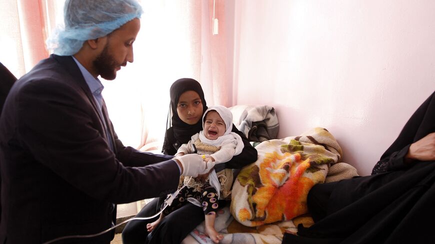  Yemeni doctor administers a test on a child at a hospital in the capital Sanaa after the World Heath Organization confirmed 11 cases of cholera in the city, Oct. 29, 2016.