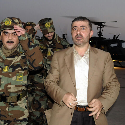 Freed Lebanese prisoner Samir Kantar (L), wearing Hezbollah military fatigues, arrives with his freed comrades (back) and Wafiq Safa (R), Hezbollah coordinator for the prisoner swap with Israel, to the airport in Beirut on July 16, 2008. Five Lebanese prisoners freed by the Israeli authorities arrived in Lebanon today, hours after Hezbollah handed over the bodies of two Israeli soldiers seized by its guerrillas two years ago. Among those freed in a prisoner swap greeted with triumph in Lebanon but anguish i