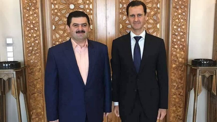 An undated image of Baraa al-Qaterji (L) with Syrian President Bashar al-Assad