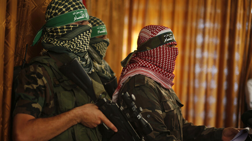 Hamas' armed wing spokesman speaks during a news conference in Gaza City July 3, 2014. The spokesman said Israel was breaking the 2012 ceasefire agreement and the group would act according to developments on the ground. He said Israel would pay a heavy price in any upcoming war. Israel said on Thursday it was beefing up its forces along its frontier with the Gaza Strip, in what it called a defensive deployment in response to persistent Palestinian cross-border rocket attacks. REUTERS/Mohammed Salem (GAZA - 