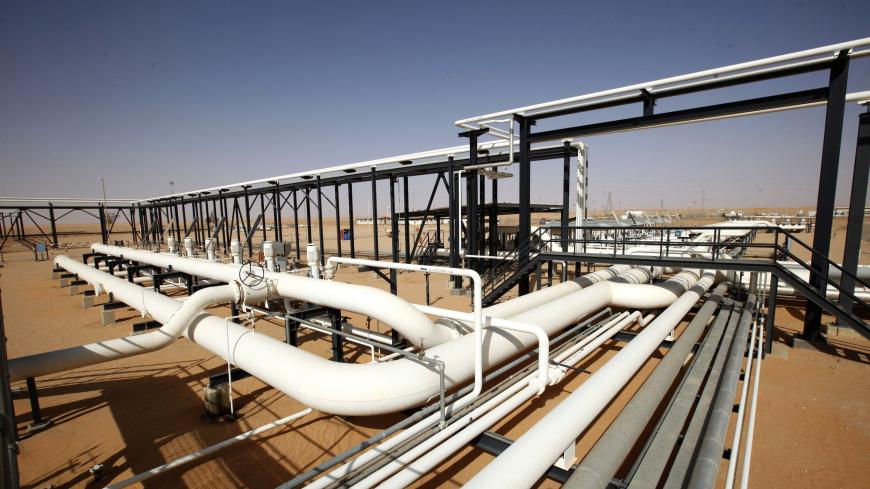 Pipes are pictured at Libya's El Sharara oilfield December 3, 2014. Deep in Libya's southern Sahara, men in army uniforms guard a pipeline at the El Sharara oilfield. Hundreds of kilometers to the north, rival fighters turn off the pumps to stop the oil flowing. The standoff over El Sharara illustrates the complex challenge United Nations mediators face in holding together a country heading towards a civil war between factions allied with rival cities scrambling for control. U.N. envoys plan to bring the Li