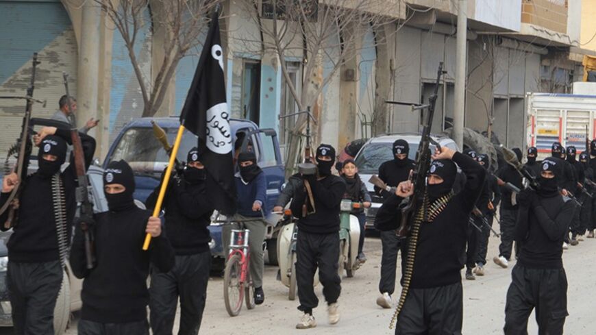 Fighters of al-Qaeda linked Islamic State of Iraq and the Levant carry their weapons during a parade at the Syrian town of Tel Abyad, near the border with Turkey January 2, 2014. Picture taken January 2, 2014. REUTERS/Yaser Al-Khodor (SYRIA - Tags: POLITICS CIVIL UNREST CONFLICT) - RTX170U3