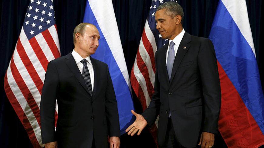 U.S. President Barack Obama extends his hand to Russian President Vladimir Putin during their meeting at the United Nations General Assembly in New York September 28, 2015. REUTERS/Kevin Lamarque  - RTX1SYBB