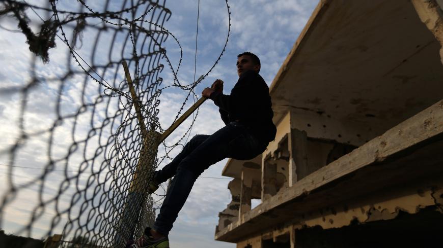 A Palestinian waits for his relatives to return into Gaza after the Egyptian Authority opened the Rafah Border Crossing for one day, in the southern Gaza Strip February 19, 2018. REUTERS/Ibraheem Abu Mustafa - RC179BE19FB0