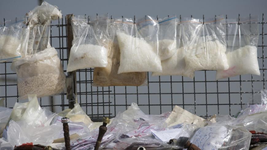 Drugs are prepared for burning during a ceremony in southern Tehran, March 9, 2009. Authorities burnt 3 tonnes of drugs confiscated in Tehran on Monday as a part of an anti-drug ceremony. REUTERS/Morteza Nikoubazl (IRAN CONFLICT SOCIETY) - RTXCK1E